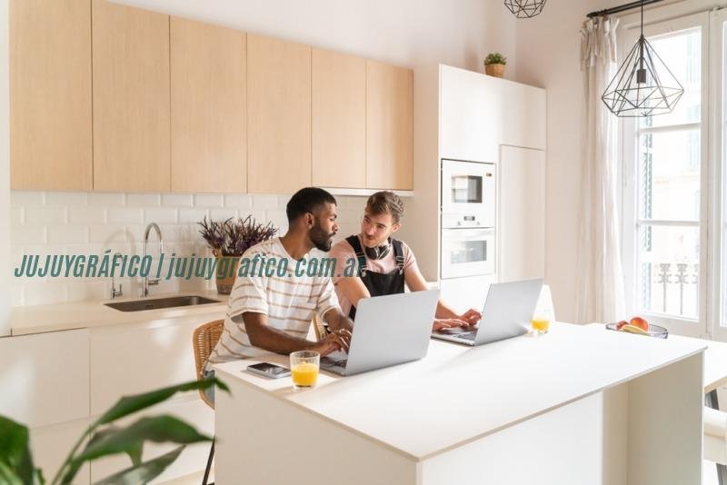 Men working from home. They are using computers and talking between each other. Men working from home. They are using computers and talking between each other.